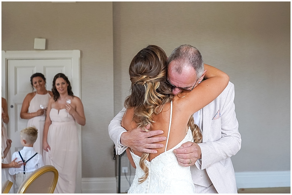 Father hugs his daughter on her wedding day
