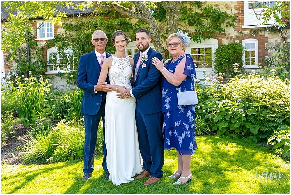 bride and groom with mum and dad at Bury Court Barn