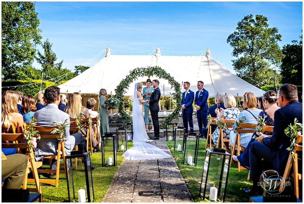Bride and groom getting married at a private marquee in their garden