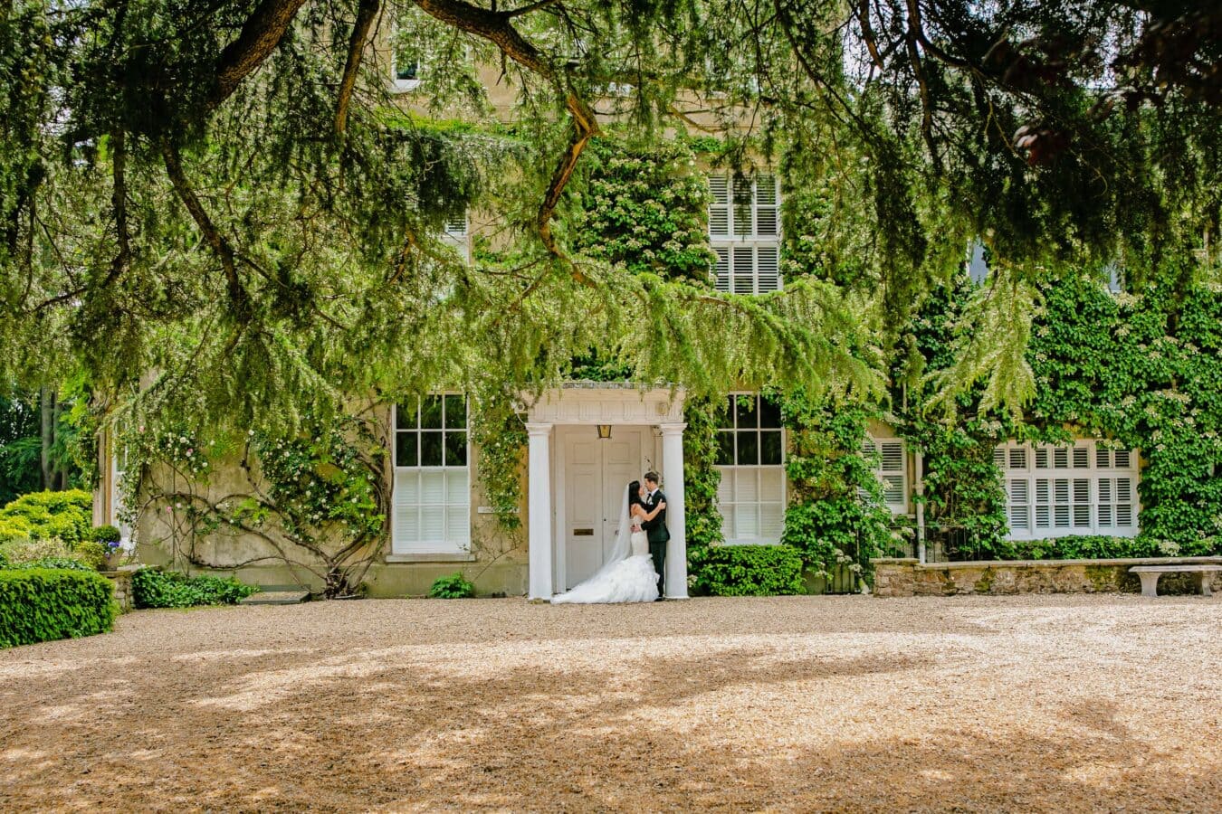 Northbrook Park Wedding Photography with a bride and groom at the main house entrance